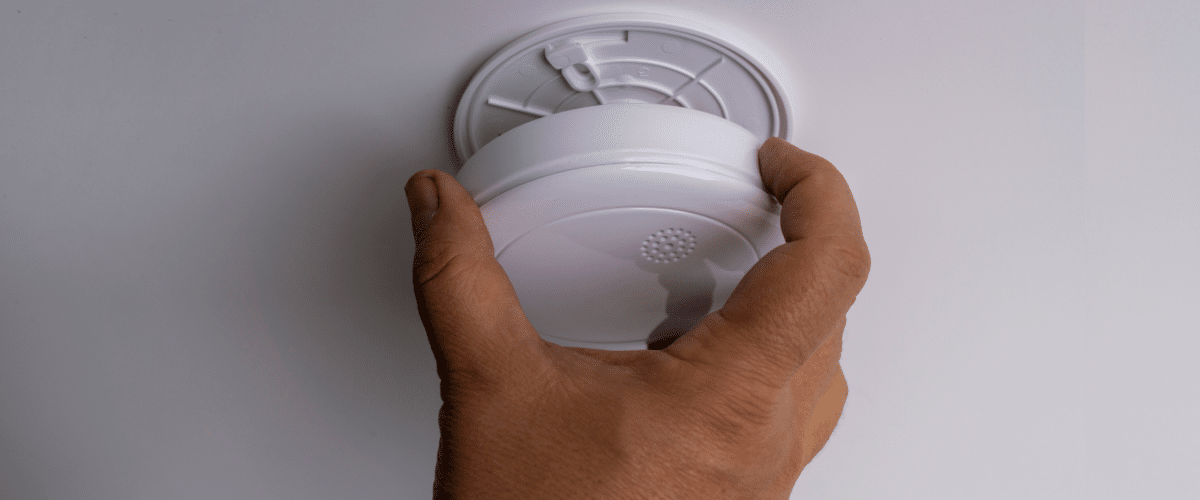 Person installing a carbon monoxide detector