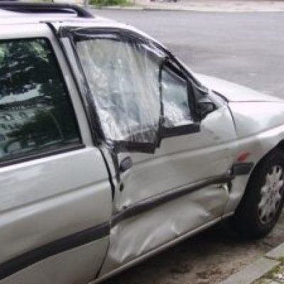 800px Damaged car door 300x225